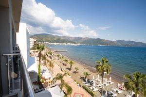 a view of a beach with palm trees and the ocean at Yunus Beach Hotel in Marmaris