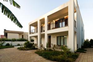 a large white building with a courtyard at Open Space San Cusumano in Erice