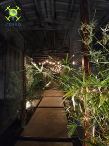 a walkway with plants and lights in a building at Wao Jungle Venao in Playa Venao