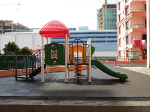a playground with a slide and a slideintend at Zoomma Marina Court Condo in Kota Kinabalu