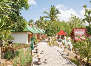 a walkway in a garden next to a building at Green Kubu Asri Villa in Nusa Penida