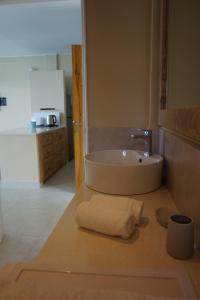 a bathroom with a sink and a towel on a counter at Maka Bay Self Catering in Victoria