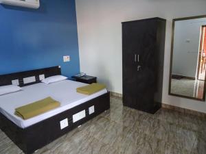 a bedroom with a large bed and a mirror at AARYA FARM in Bhom