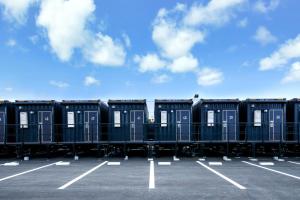 a row of portable toilets in a parking lot at HOTEL R9 The Yard Miyakojima in Miyako Island