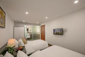 Postel nebo postele na pokoji v ubytování Hanoi Aria Central Hotel & Spa