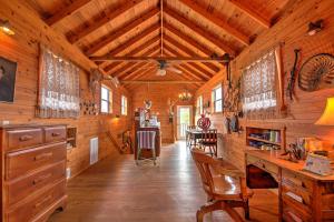a wooden cabin with a desk and chairs in it at Ark Bunkhouse Fredericksburg Hideaway with Hot Tub in Fredericksburg