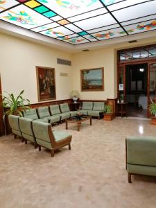 a waiting room with couches and a colorful ceiling at Hotel Antico Borgo in Riolo Terme