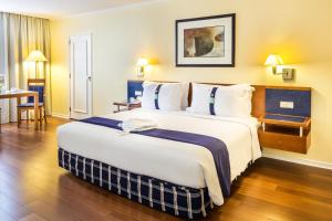 a large bed in a hotel room at Holiday Inn Lisbon by IHG in Lisbon