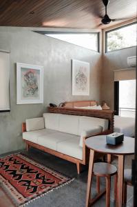 a living room with a white couch and a bed at T Lofts in Seminyak