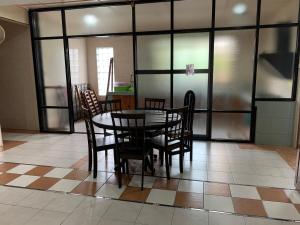 a dining room with a table and chairs at Shangrila House @ 香格里拉民宿 in Tawau