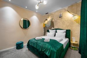 a bedroom with a green bed and a mirror at Rabbit Hole in Sibiu