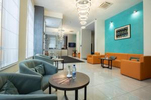 a lobby with couches and tables in a hospital at Raziotel Kyiv Yamska in Kyiv