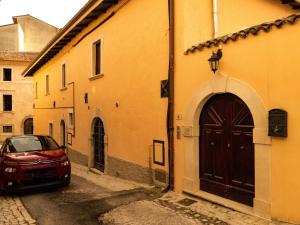 a car parked in an alley next to a building at IL NIDO L'Aquila in LʼAquila