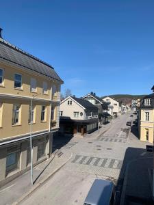 an empty street in a small town with buildings at Notodden Sentrum Apartment NO 6 in Notodden