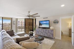 a living room with a couch and a tv at Chalet 1005 in Marco Island