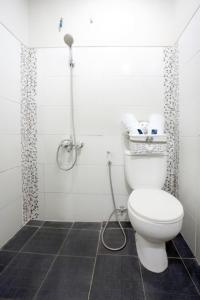 a bathroom with a toilet and a shower at D'Paragon Bukit Dieng in Malang