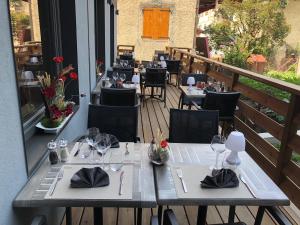 a restaurant with tables and chairs on a balcony at Hotel L'alpin in Landry