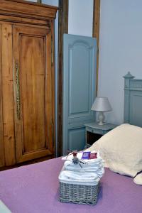 a bedroom with a bed and a dresser at Un Mas en Ville in Marseille