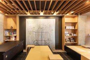 a room with a door with a drawing on the wall at Tabist KIYOMIZU Gion in Kyoto