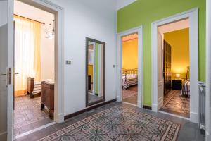 a room with green and white walls and a mirror at Fermata Jonia in Giarre
