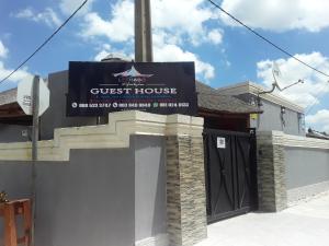 a guest house sign on the side of a building at Lethabo Guest House in Elandsfontein