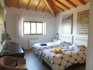 a bedroom with two beds and a desk at The Pool House in Longos