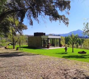 a small house in the middle of a green field at Quinta da Chouza Agroturismo e Enoturismo in Celorico de Basto