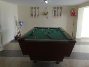 a pool table with balls on top of it in a room at Apartament vila Roma in Eforie Nord