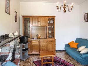 a living room with a blue couch and a cabinet at Holiday Home Cristina-2 by Interhome in Santa Lucia