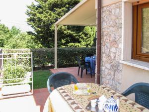 a patio with a table and chairs on a patio at Apartment Cristina-3 by Interhome in Santa Lucia