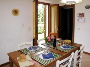 uma mesa de jantar com cadeiras e uma mesa com copos de vinho em Apartment Cristina-3 by Interhome em Santa Lucia