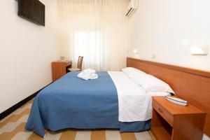 Giường trong phòng chung tại B&B Italia