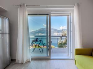 a room with a sliding glass door with a view of the ocean at Apartment La Maison Blanche-2 by Interhome in Brenzone sul Garda