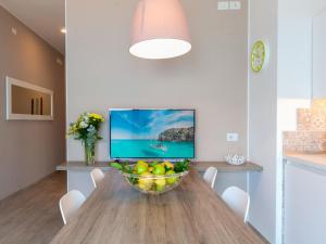 a dining room with a table with a bowl of fruit at Apartment La Maison Blanche-2 by Interhome in Brenzone sul Garda +18 photos