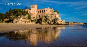 a castle on an island in the water at Villa BelaVista with Private Pool in Ferragudo