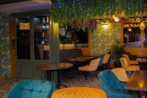 a restaurant with tables and chairs and plants at OYO The Townhouse in Durham