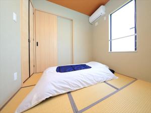 a bed in a room with a window at COTO Tokyo Asakusa 5 in Tokyo