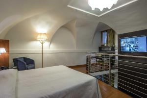 a bedroom with a bed and a tv in a room at Albergo del Senato in Rome