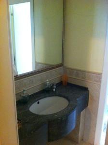 a bathroom with a sink and a large mirror at Hotel Ave in Rimini