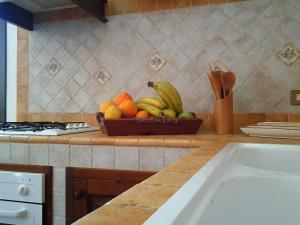 a bowl of fruit on a counter in a kitchen at Casa Claudia in San Vito lo Capo