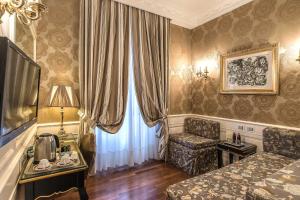 a hotel room with a bed and a chair and a window at Albergo del Senato in Rome