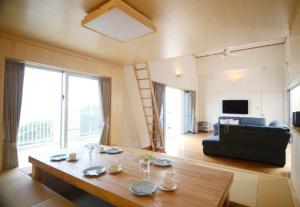 a living room with a table and a couch at Kasane / The Family Villa in Ishigaki Island