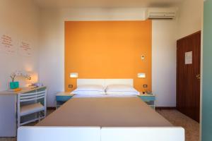 A bed or beds in a room at Mini Hotel