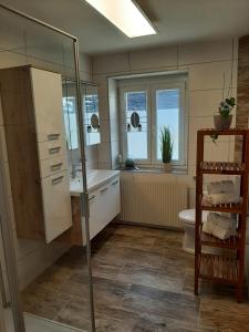 a bathroom with a shower and a sink and a toilet at Ferienwohnung "Marie's Auszeit" in Bodensdorf