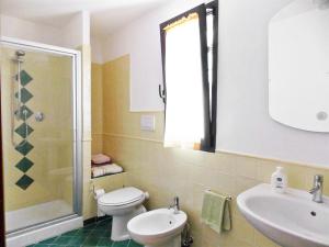 a bathroom with a toilet and a sink and a shower at Villa Il Circolo by Interhome in Borselli