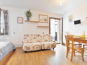sypialnia z łóżkiem, kanapą i biurkiem w obiekcie Studio Apt 14 by Interhome w mieście Alba di Canazei