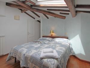 a bedroom with a bed with two towels on it at Villa Lorenzo by Interhome in Forte dei Marmi