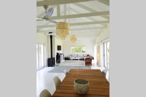 a dining room with a wooden table and a couch at Where the Heart is in Knysna