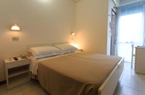 A bed or beds in a room at Mini Hotel