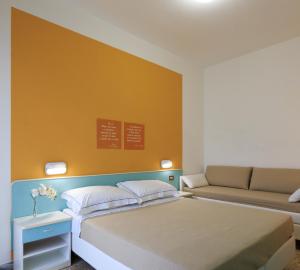 A bed or beds in a room at Mini Hotel